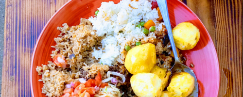 Pilau served with roasted potatoes and sauteed vegetables