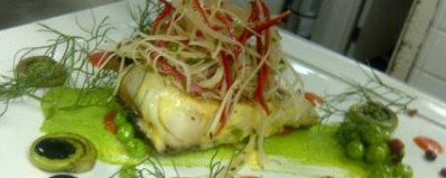 Seared black cod with butter poached lobster and spring peas