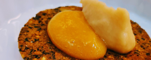 Pine nut wafer with foie shavings and peach compote
