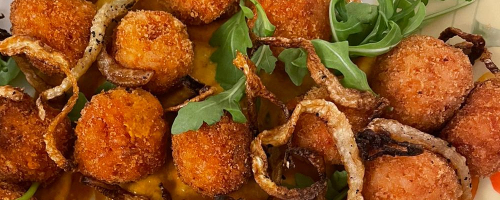 Arancini on two pepper sauce and crispy fennel