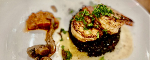 Grilled gambas on black rice, black butter sauce