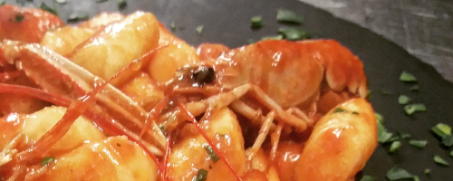 Gnocchi with spicy prawn sauce.